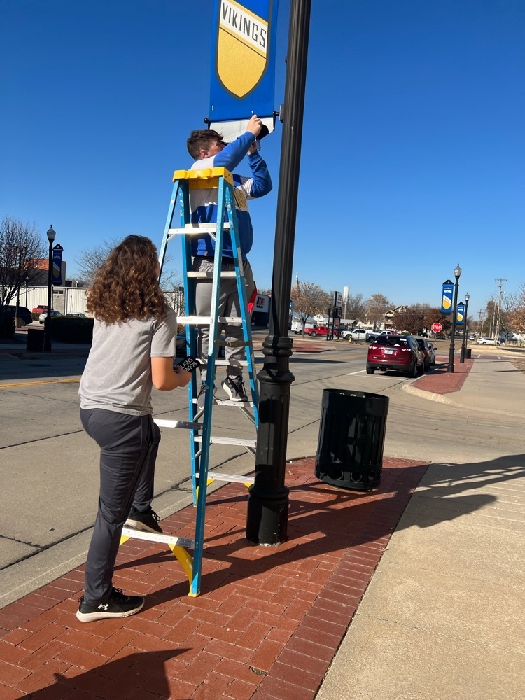 Seniors installed the Booster Club Supporter names today on the downtown banners on 18th street