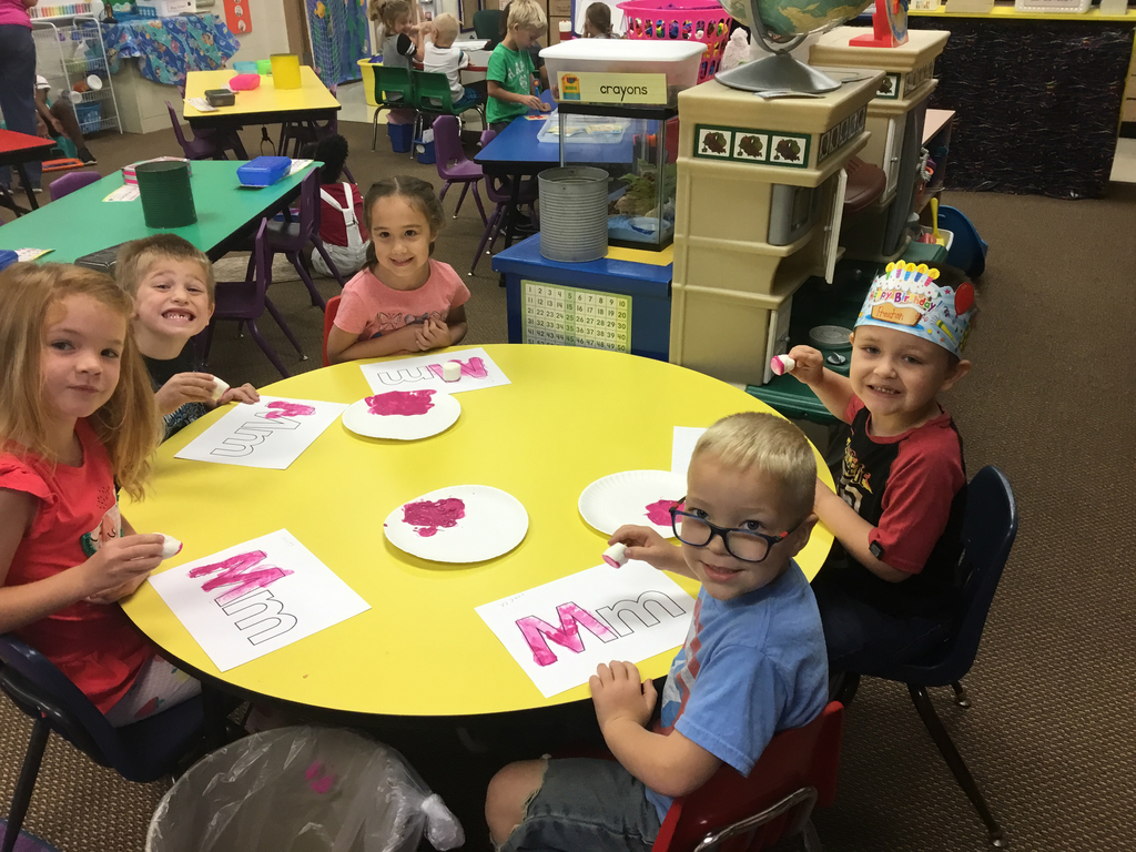 Painting the letter Mm using marshmallows and magenta paint!