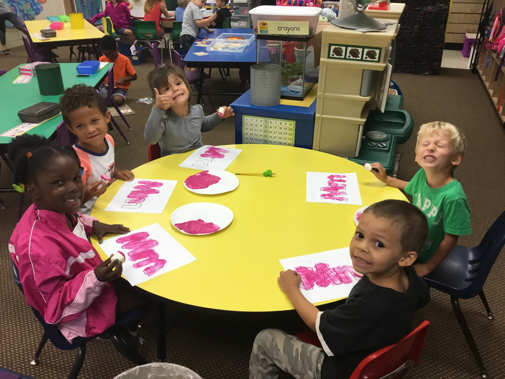 Painting the letter Mm using marshmallows and magenta paint!
