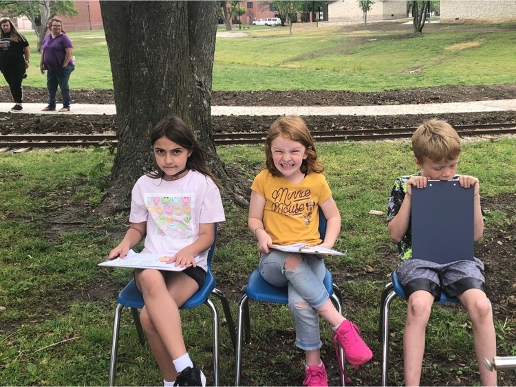 students ready to read at the park