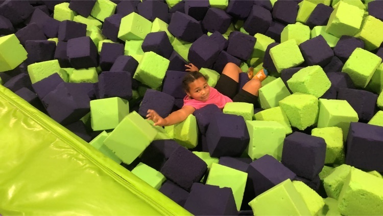 student in ball pit