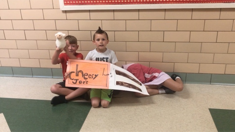 students with their sandwich shop sign