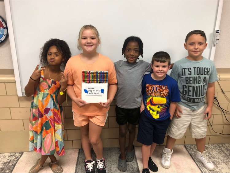 Students posing with their crayon canvas.