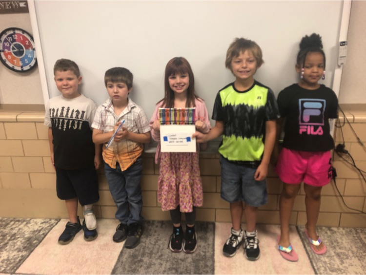 Students posing with their crayon canvas.