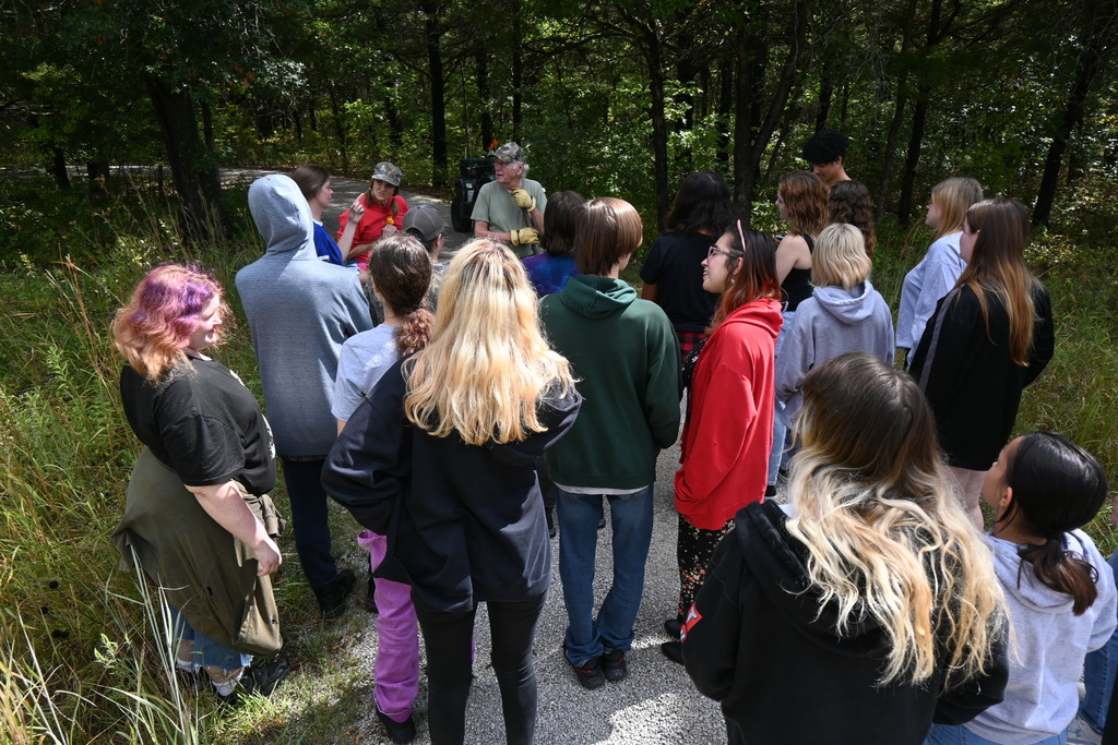 Students listen to Max and Eweleen Good as they enter the Good Woods.
