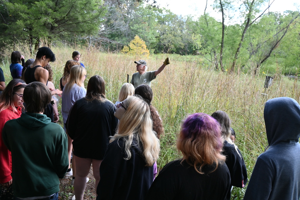 Max explains to students about some of the prairie grasses