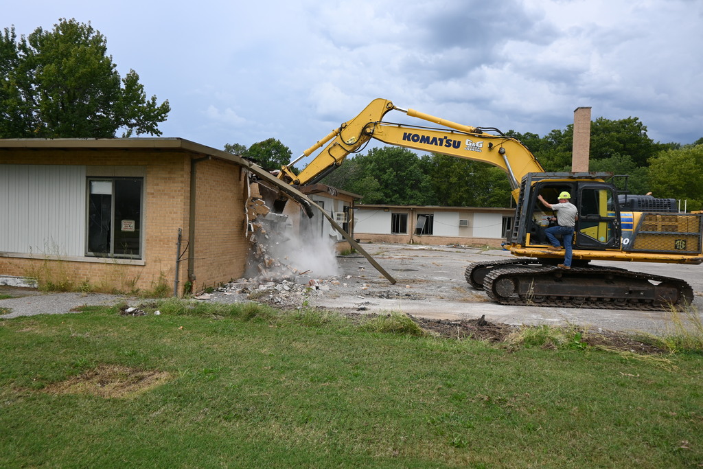 The excavator makes its first bite into awall of Washington School.