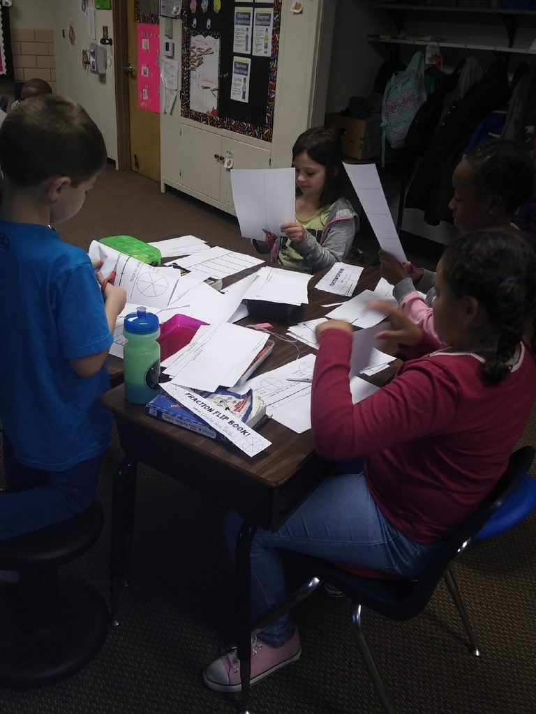 The kids working on making their faction book to use while we are learning about fractions